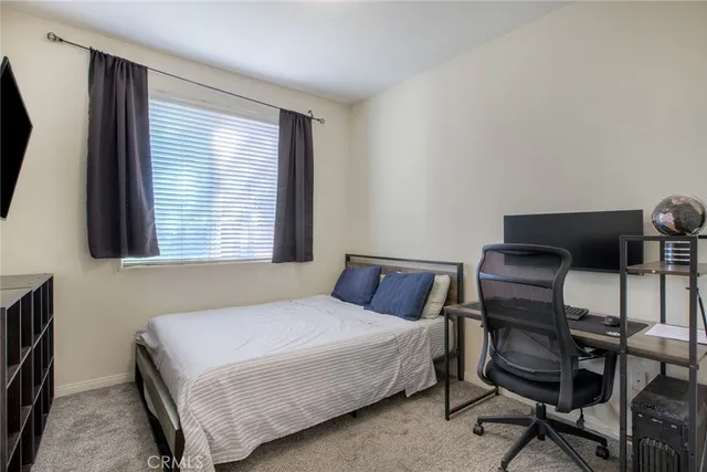 a bedroom with a bed and a chair in it