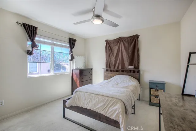 a bedroom with a bed and a television