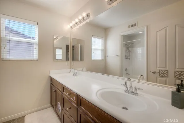 a bathroom with a double vanity sink and a mirror
