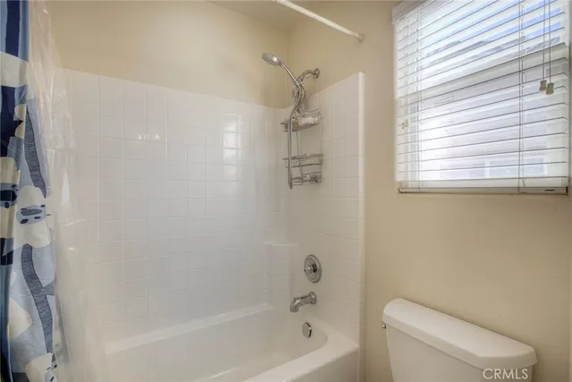 a bath room with a toilet and a bath tub