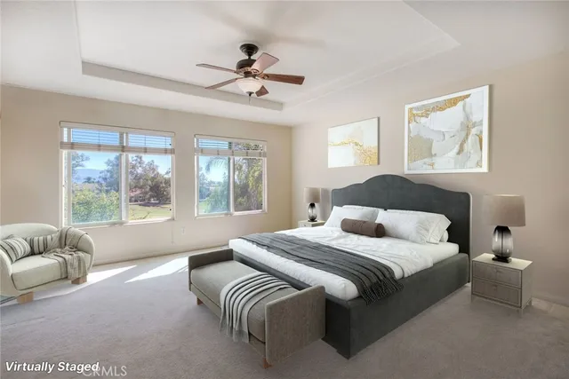 a bedroom with a large bed couch and windows