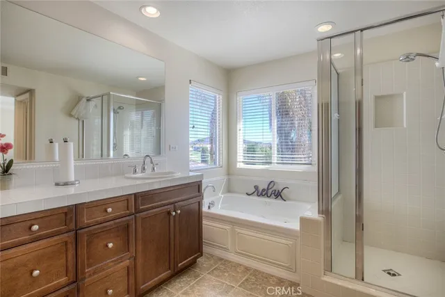 a spacious bathroom with a granite countertop sink mirror and shower