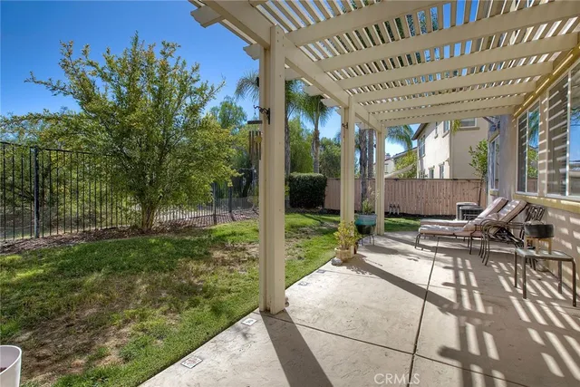 a view of a chair and tables in the patio in front of a house