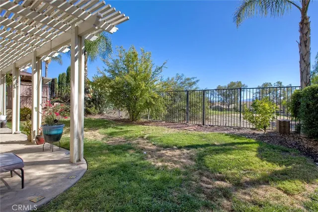 a view of a patio with table and chairs and potted plants