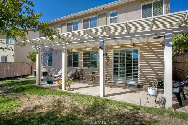 a view of a house with backyard porch and sitting area