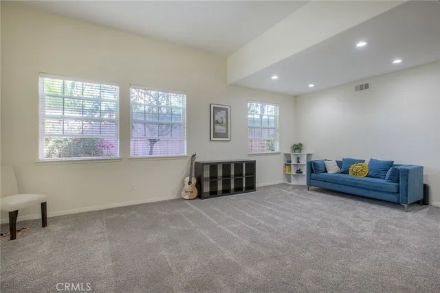 a spacious bedroom with a bed and a couch