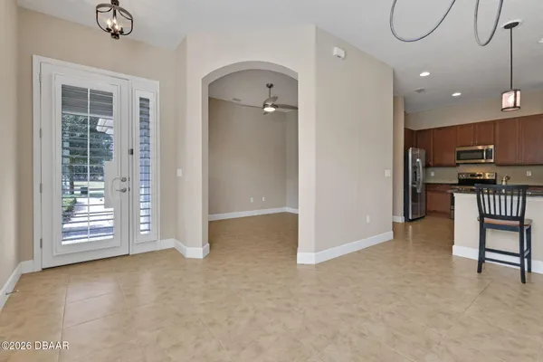 an empty room with windows & cabinet