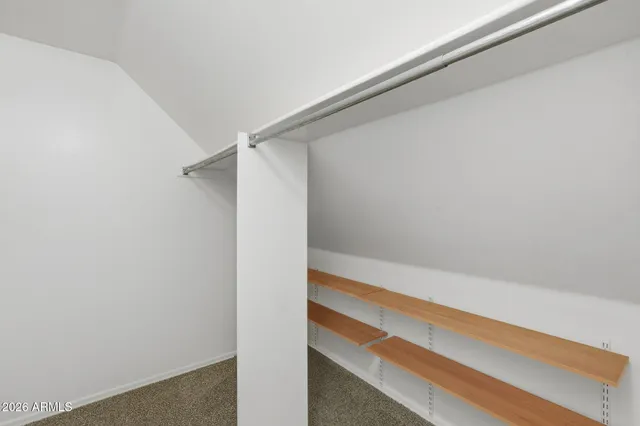 an empty room with a ceiling fan and a fan