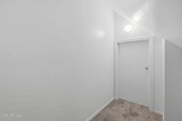 a view of an empty room with white walls