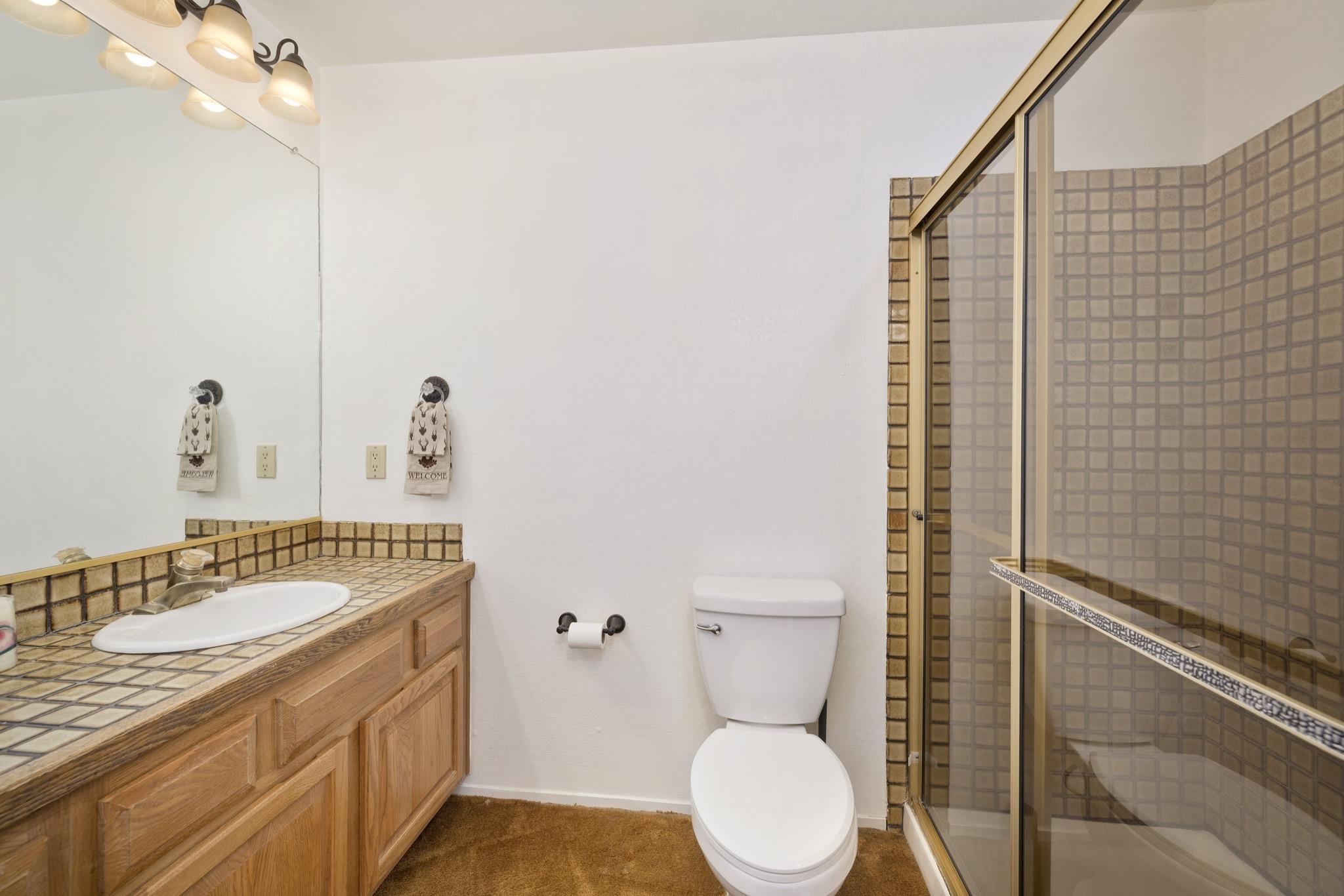 484 Manzanita Road, Unit 16 Mammoth Lakes, CA 93546 - Photo 20 of 34 a bathroom with a granite countertop toilet sink and mirror