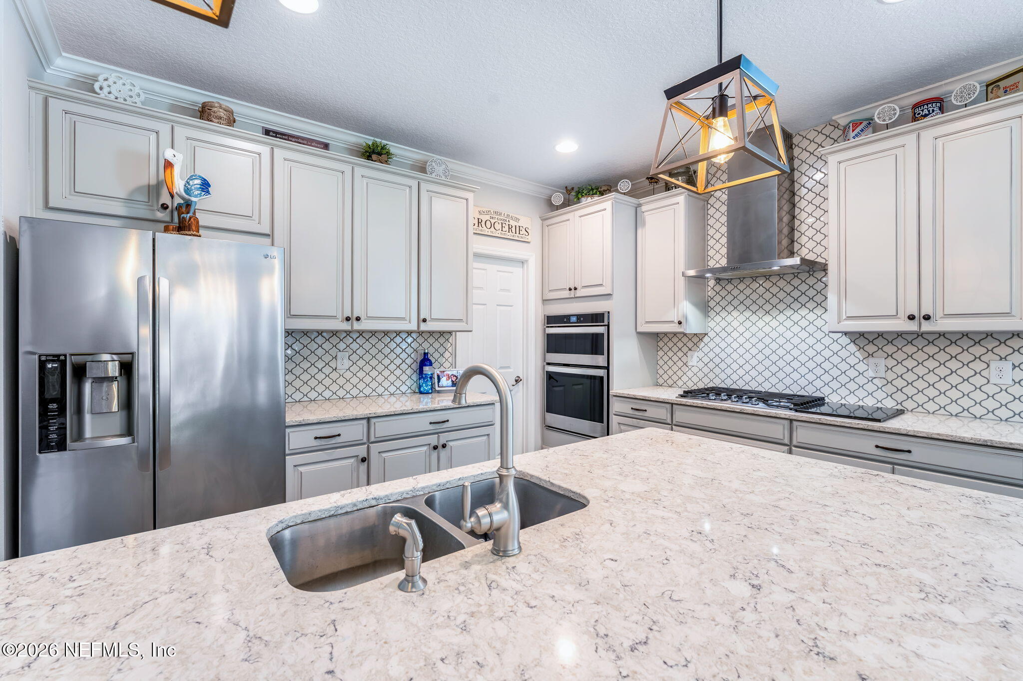 175 Convex Lane St. Augustine, FL 32095 - Photo 17 of 66 a kitchen with stainless steel appliances kitchen island granite countertop a refrigerator and a sink