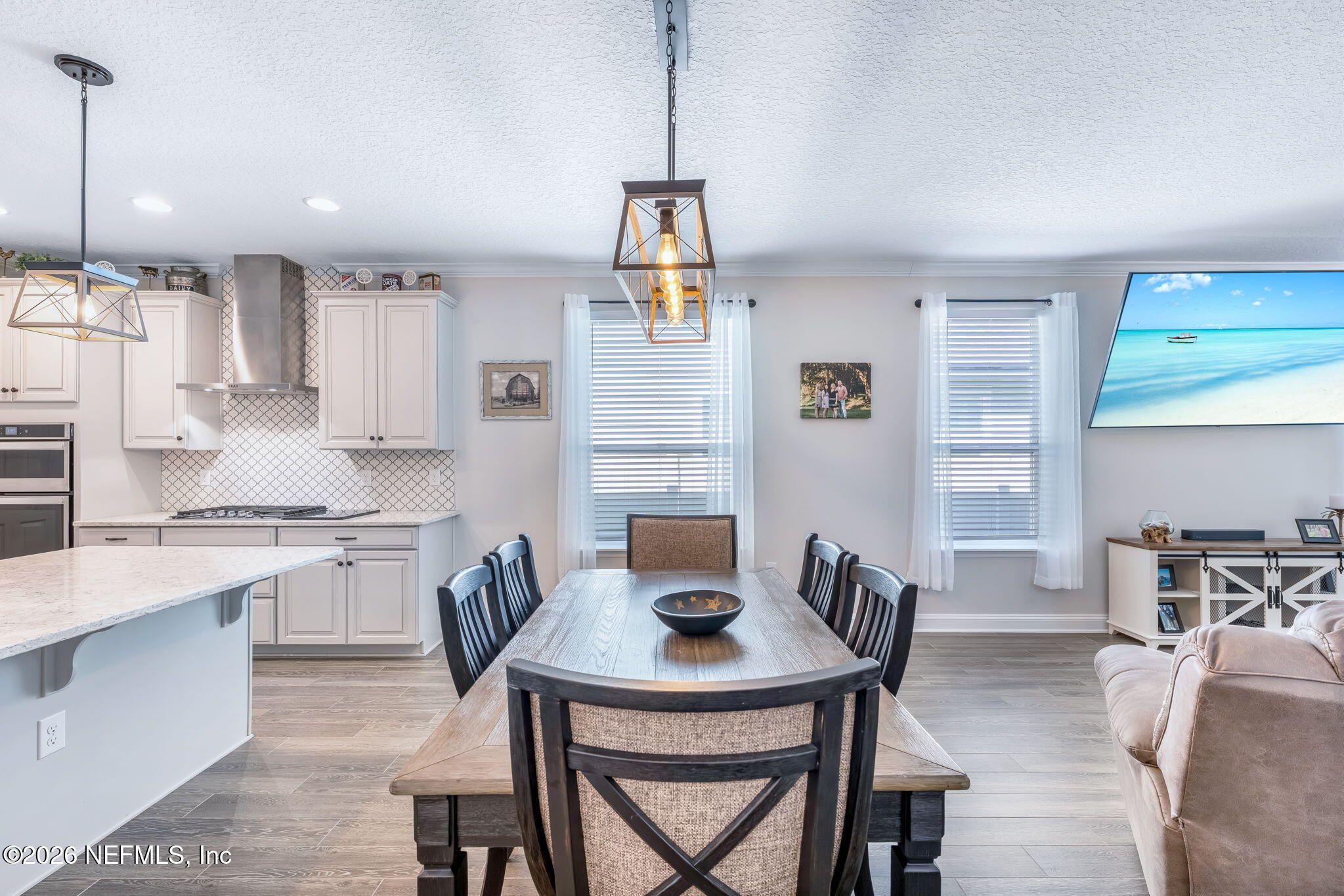 175 Convex Lane St. Augustine, FL 32095 - Photo 21 of 66 a kitchen with stainless steel appliances granite countertop a stove a refrigerator a kitchen island a dining table and chairs