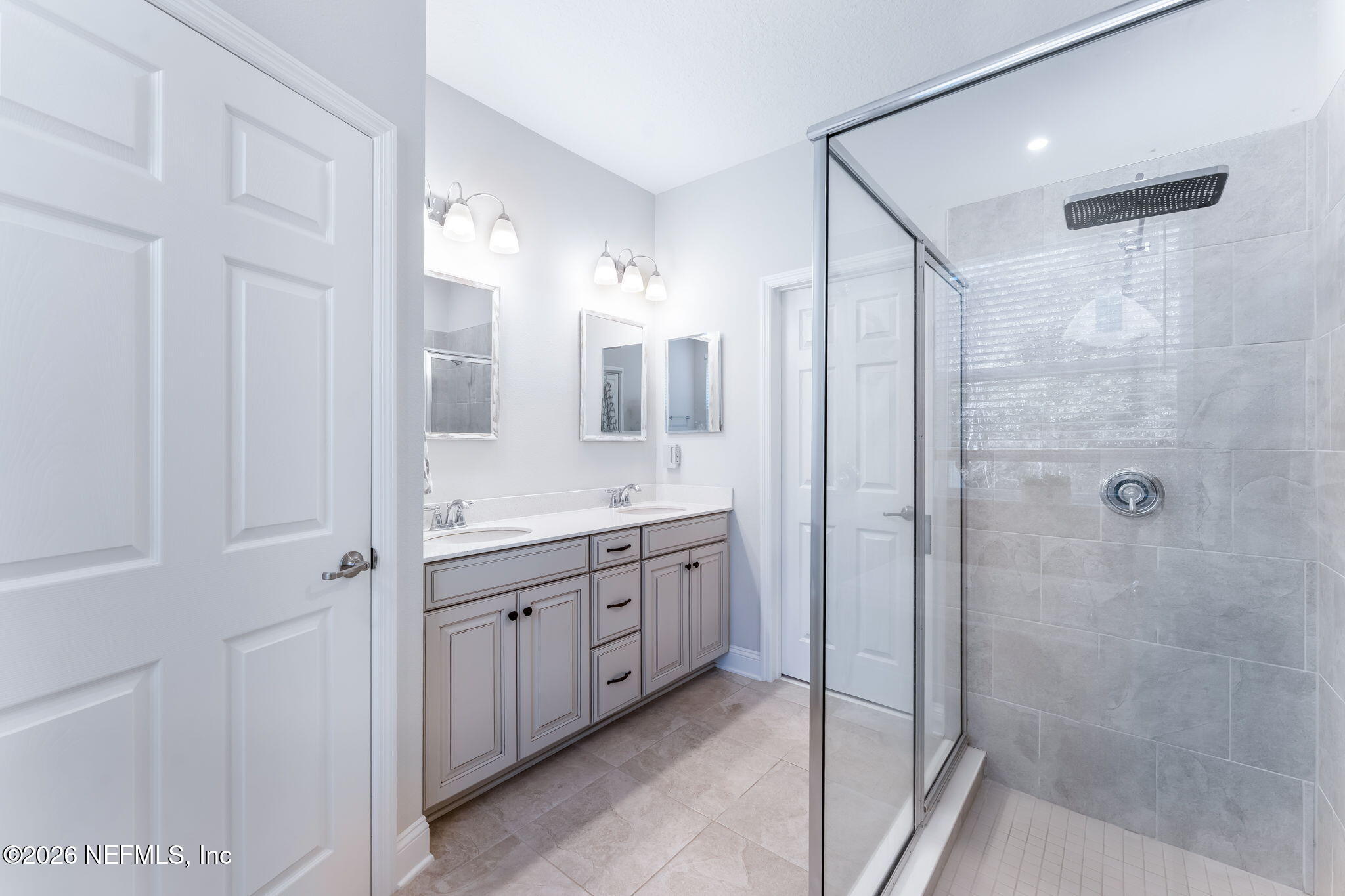 175 Convex Lane St. Augustine, FL 32095 - Photo 29 of 66 a bathroom with a double vanity sink mirror and shower