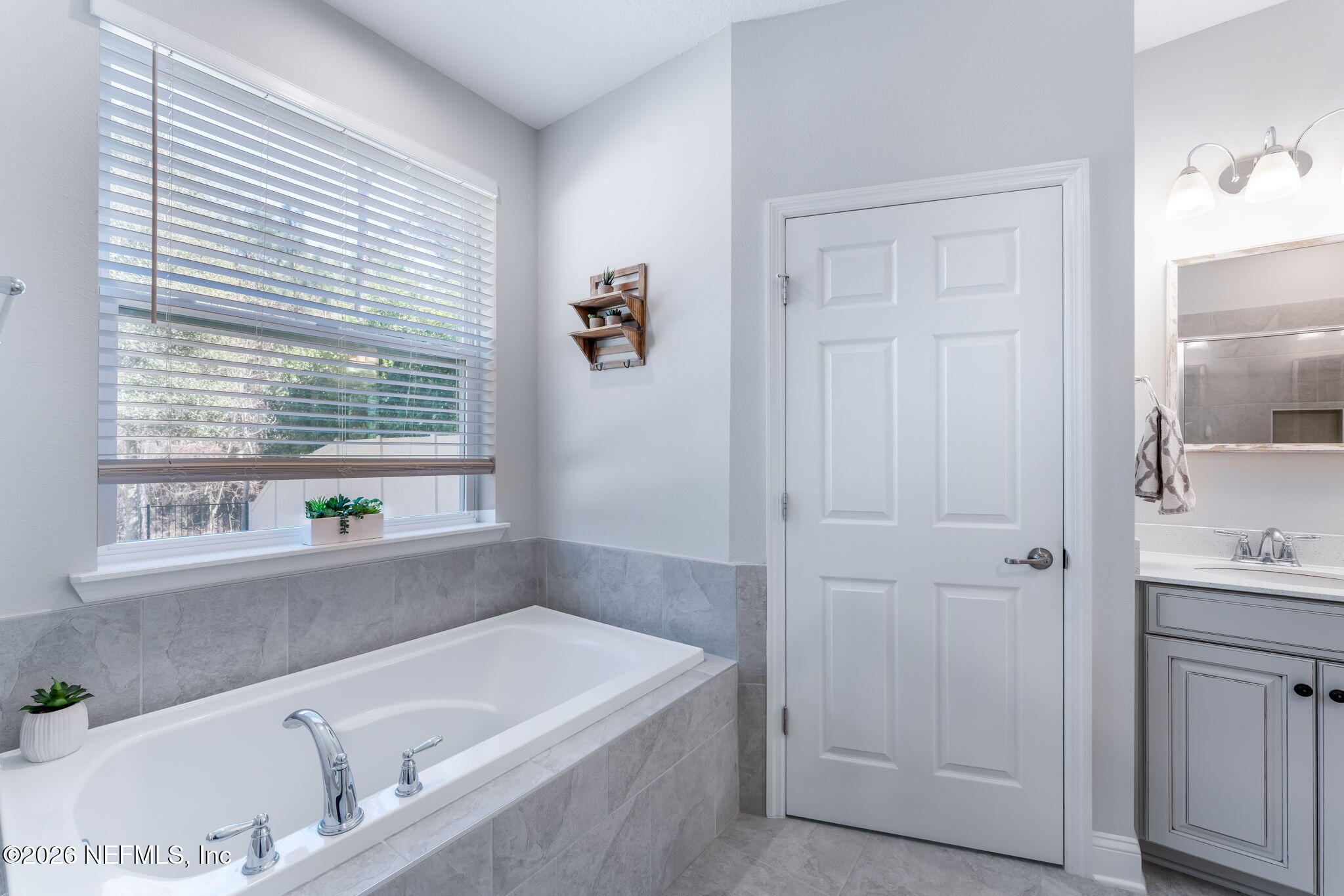 175 Convex Lane St. Augustine, FL 32095 - Photo 30 of 66 a bathroom with a tub a sink and a window