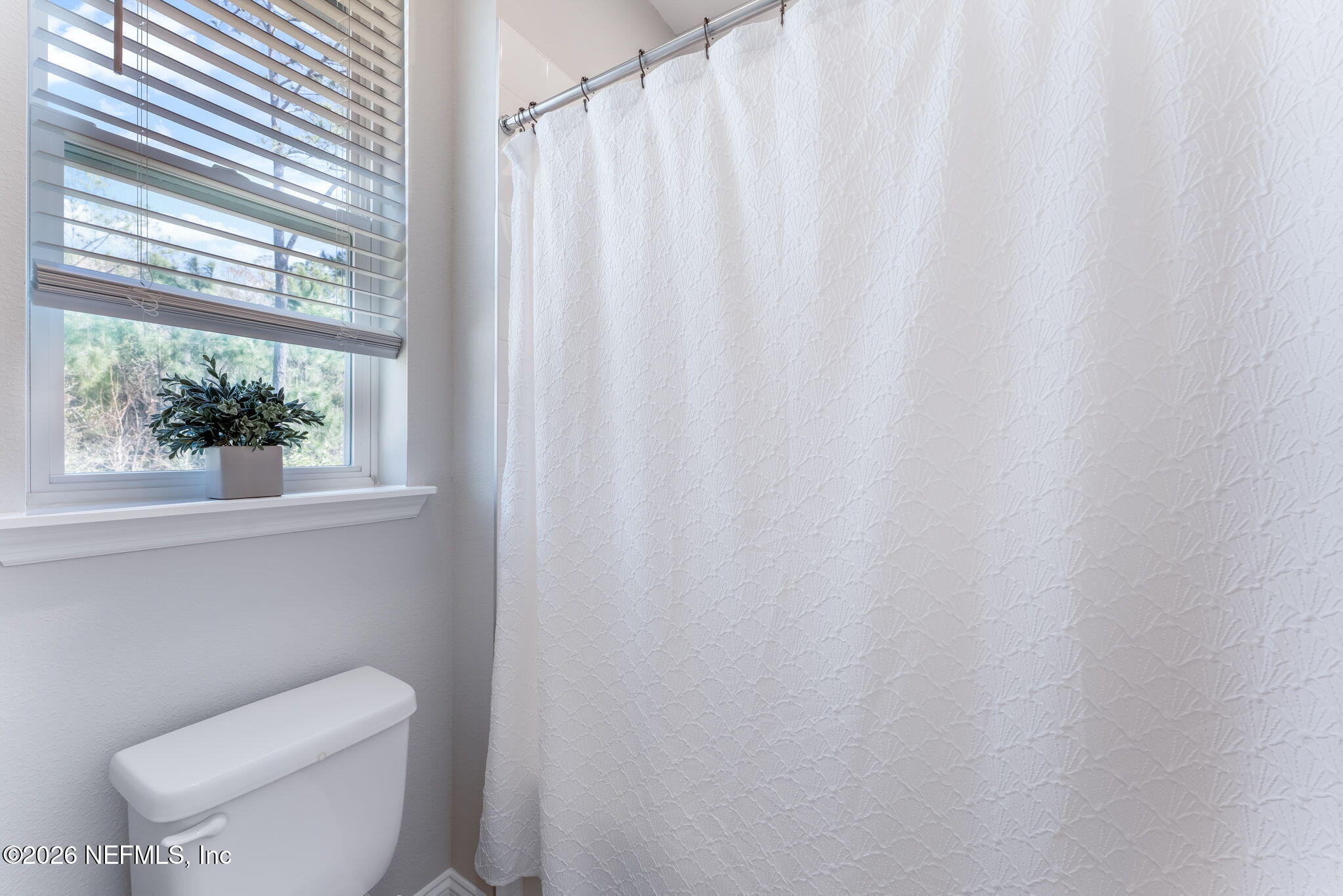175 Convex Lane St. Augustine, FL 32095 - Photo 41 of 66 a white toilet sitting next to a small window