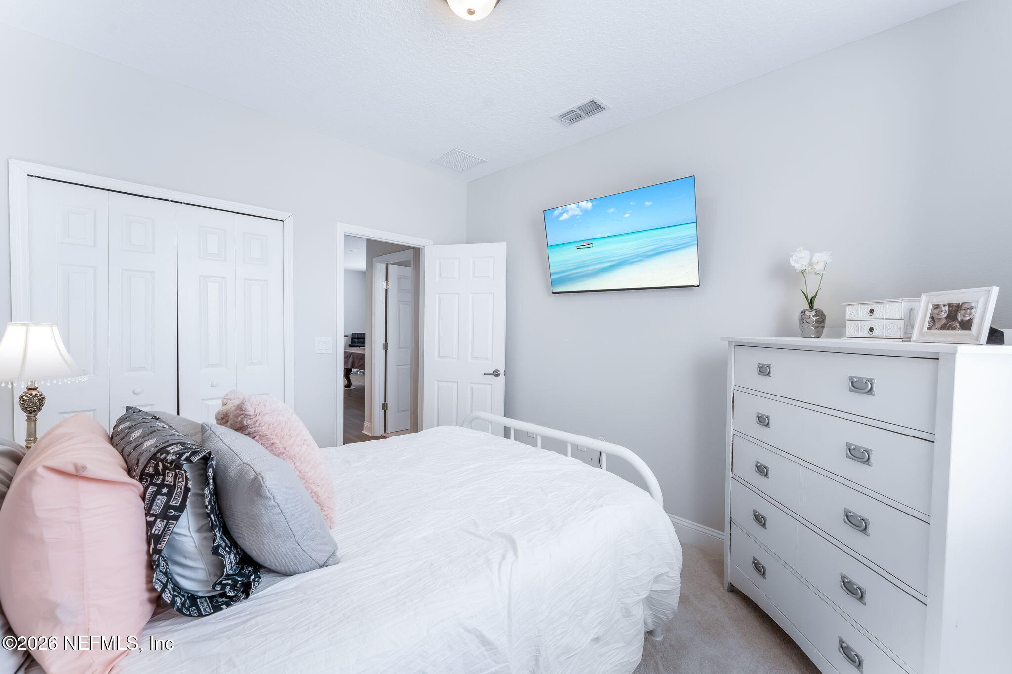 175 Convex Lane St. Augustine, FL 32095 - Photo 46 of 66 a bedroom with a bed and a lamp on dresser