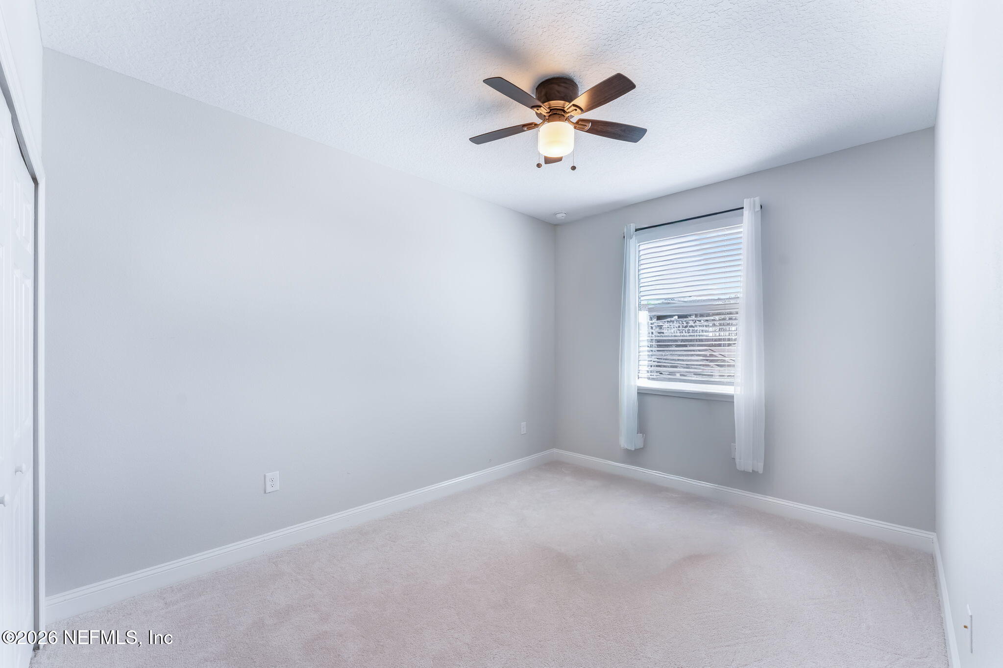 175 Convex Lane St. Augustine, FL 32095 - Photo 49 of 66 an empty room with windows and chandelier fan
