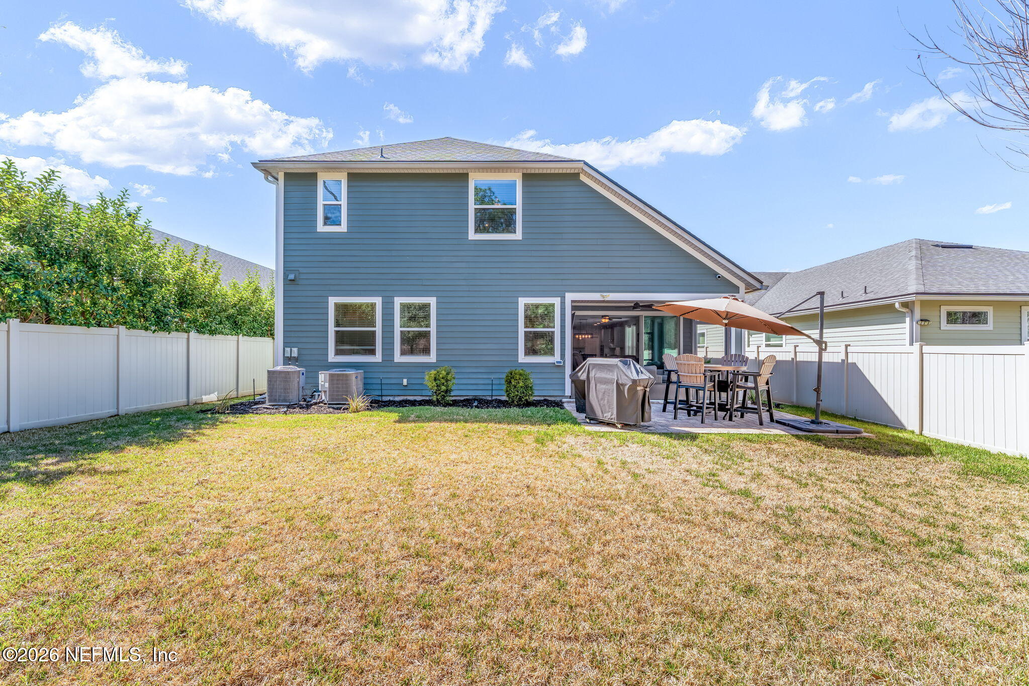 175 Convex Lane St. Augustine, FL 32095 - Photo 55 of 66 a view of a house with floor to ceiling windows and a yard