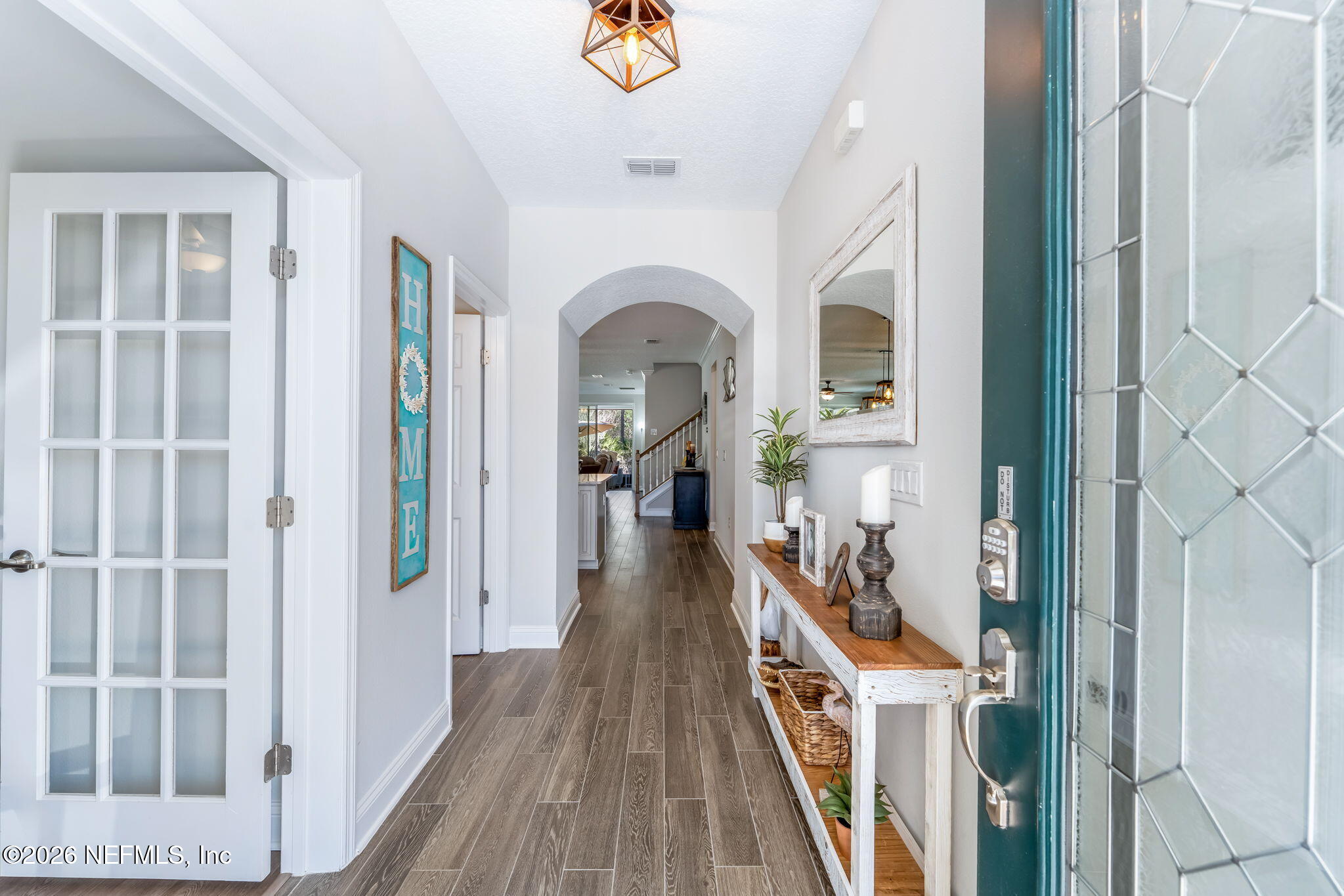 175 Convex Lane St. Augustine, FL 32095 - Photo 7 of 66 a view of a hallway view with wooden floor and staircase