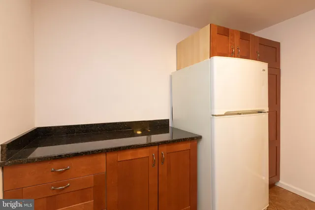 a black refrigerator freezer sitting in a kitchen