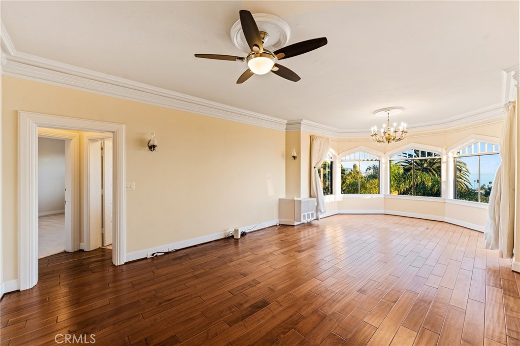 770 Hillcrest Drive, Unit 7 Laguna Beach, CA 92651 - Photo 13 of 30 a view of an empty room with wooden floor and a window