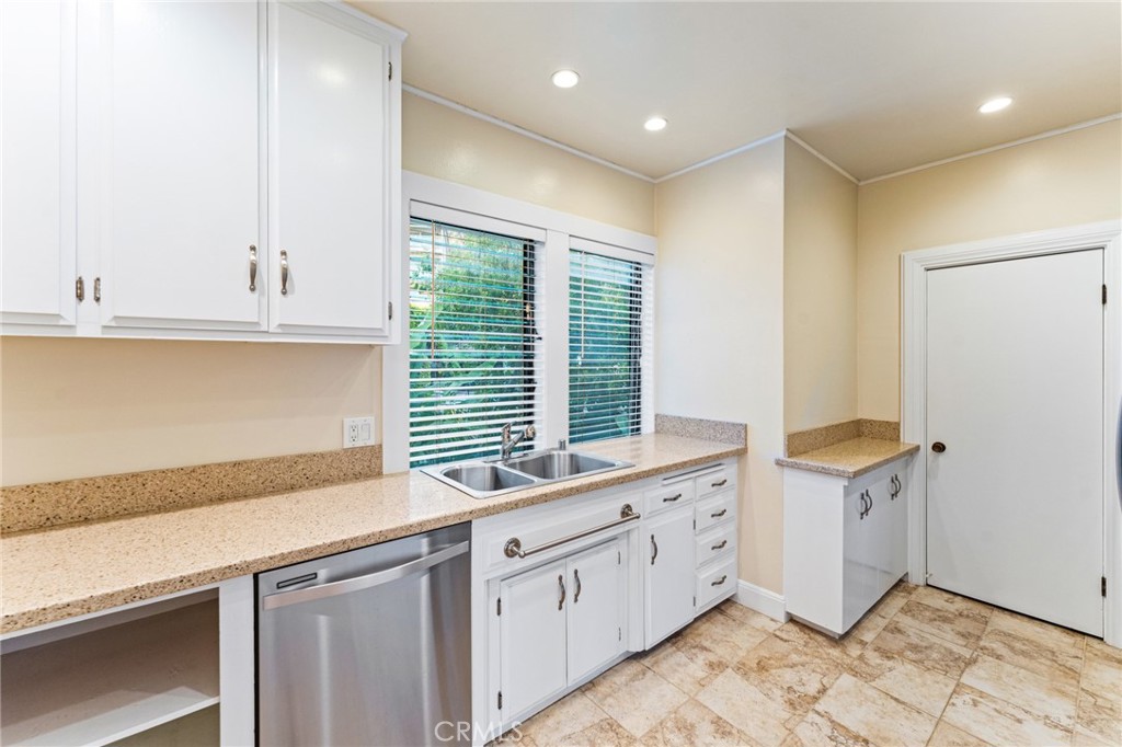 770 Hillcrest Drive, Unit 7 Laguna Beach, CA 92651 - Photo 8 of 30 a kitchen with granite countertop a sink and a stove