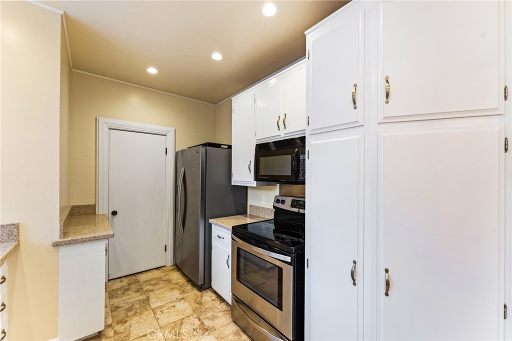 770 Hillcrest Drive, Unit 7 Laguna Beach, CA 92651 - Photo 10 of 30 a kitchen with stainless steel appliances a refrigerator stove and microwave