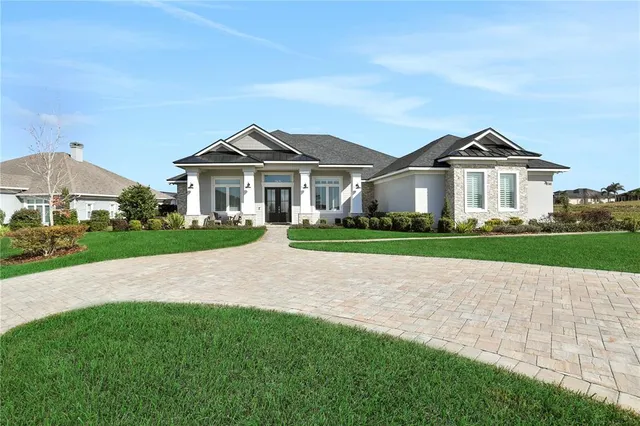 a front view of a house with a garden and plants