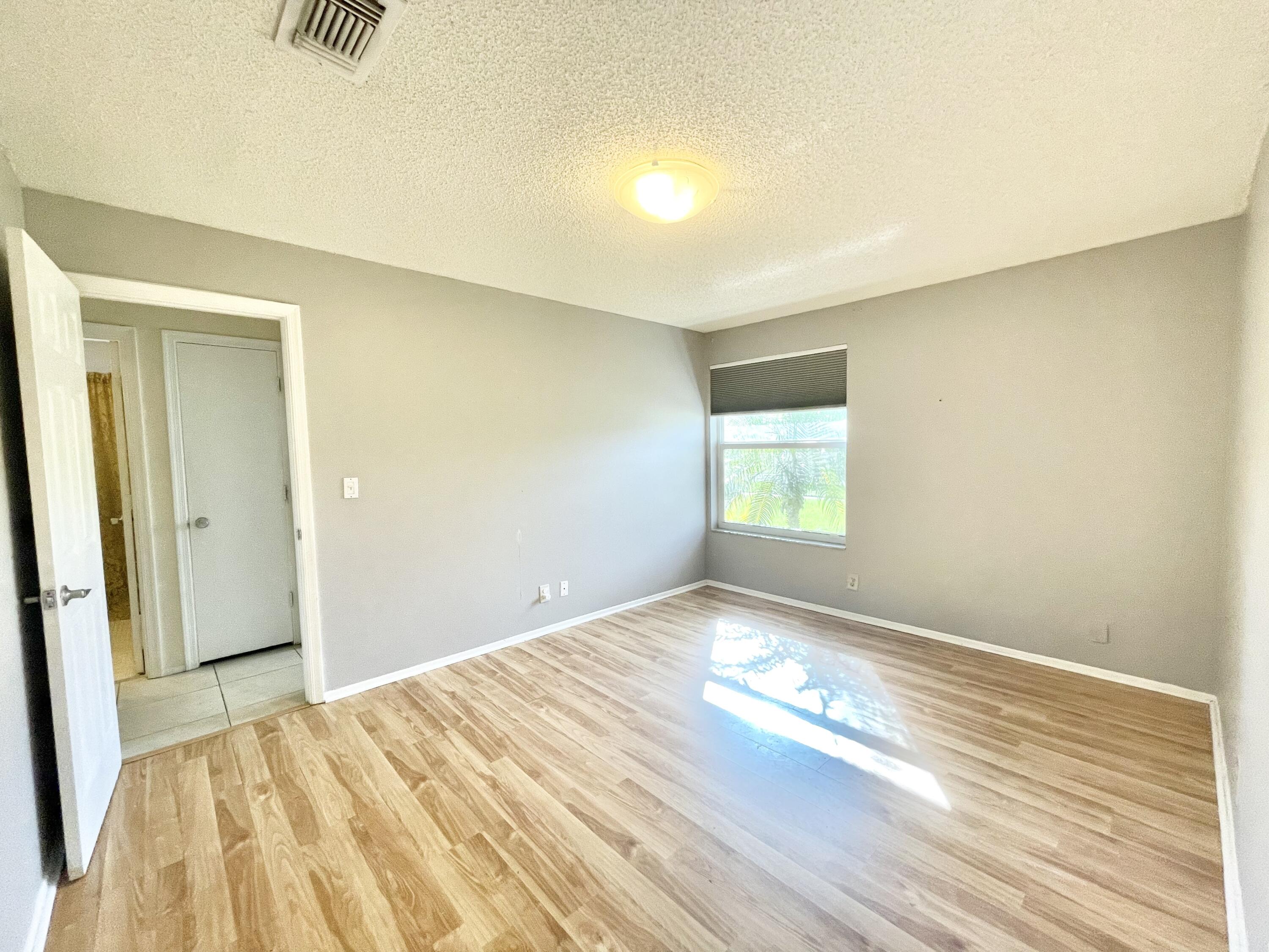 9505 Ohio Place Boca Raton, FL 33434 - Photo 13 of 44 a view of empty room with wooden floor and fan