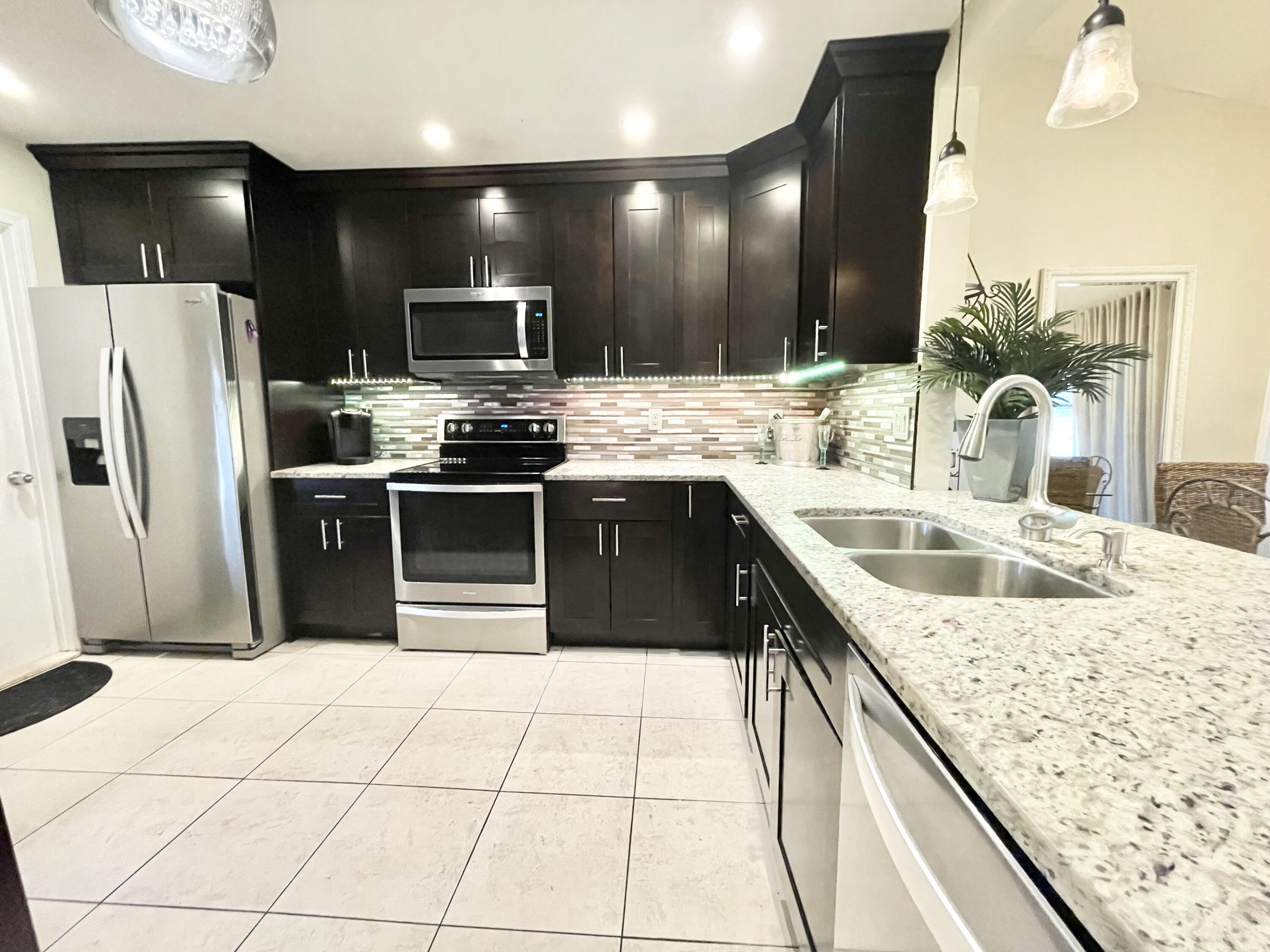 9505 Ohio Place Boca Raton, FL 33434 - Photo 8 of 44 a kitchen with stainless steel appliances kitchen island granite countertop a sink and a refrigerator