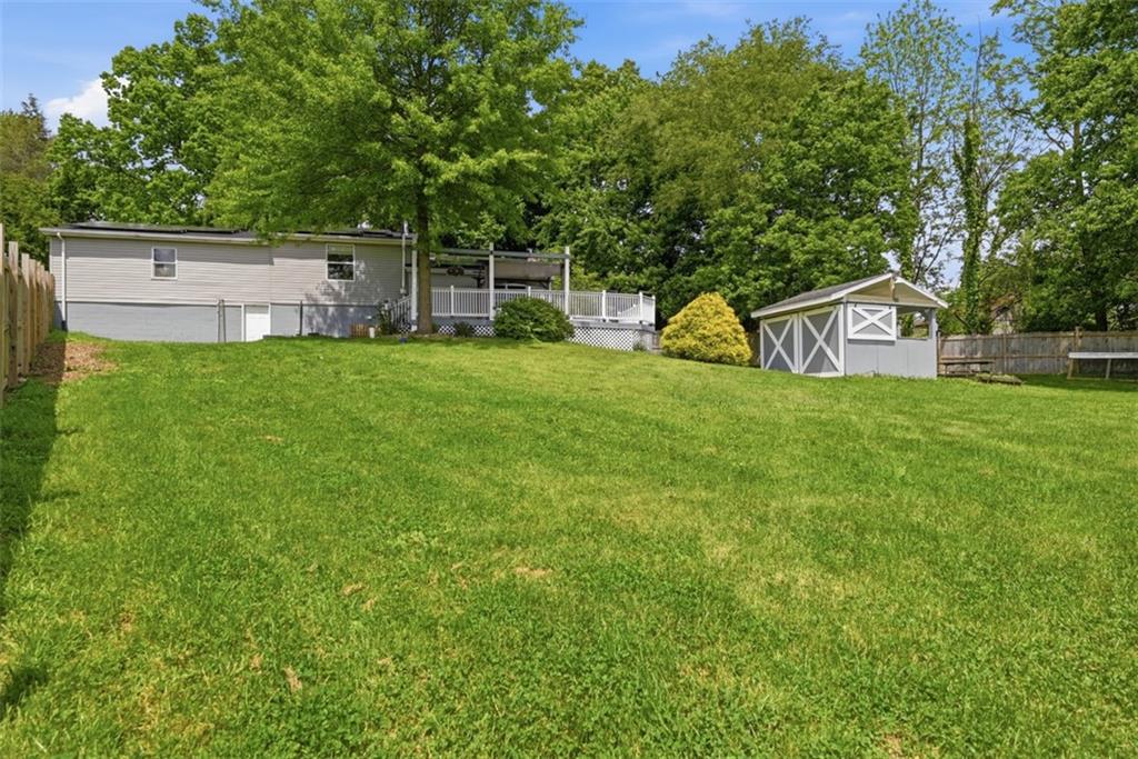 108 Connoquenessing School Road Connoquenessing, PA 16027 - Photo 35 of 50 a view of a house with a yard and sitting area