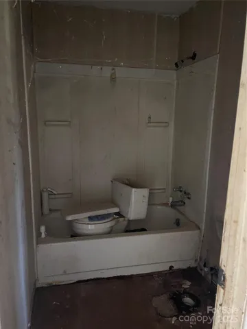 a view of kitchen with wooden floor and a fireplace