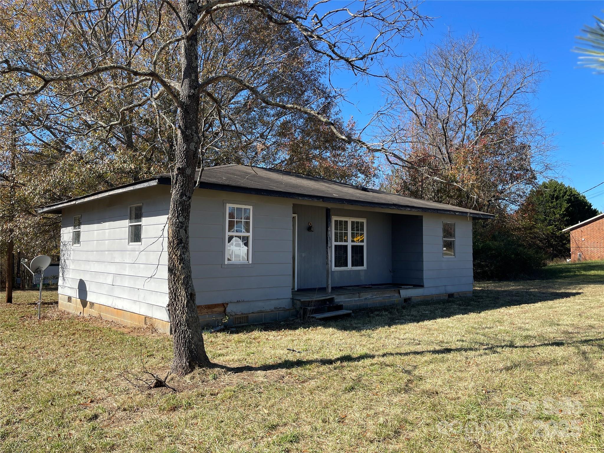 5735 Fallston Road Lawndale, NC 28090 - Photo 3 of 17 a house with trees in the background