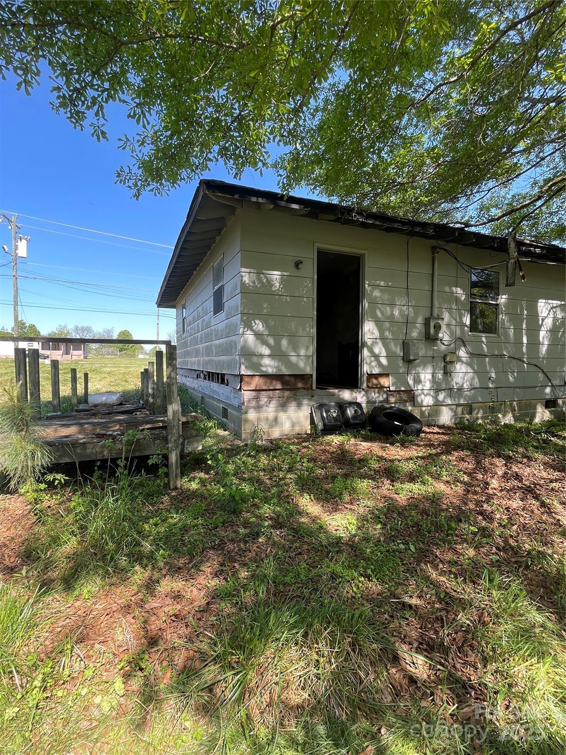 5735 Fallston Road Lawndale, NC 28090 - Photo 7 of 17 a backyard of a house with barbeque oven fire pit table and chairs