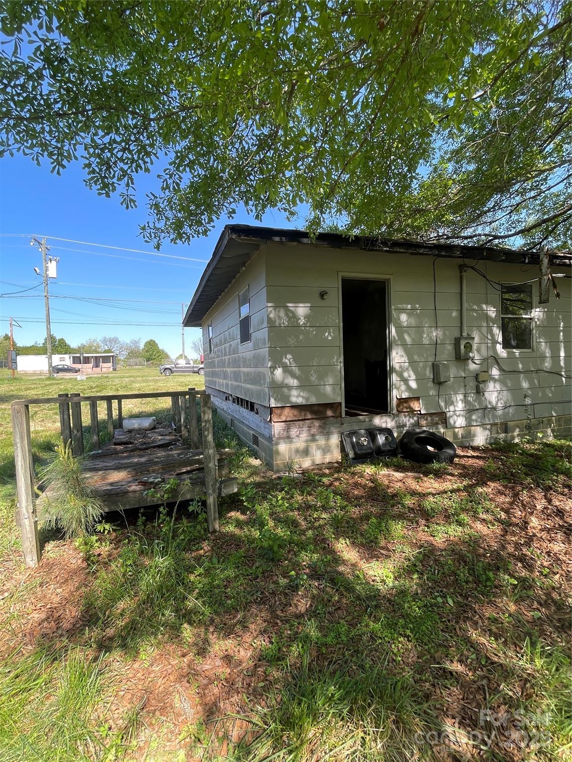 5735 Fallston Road Lawndale, NC 28090 - Photo 8 of 17 a view of a wooden house with a yard