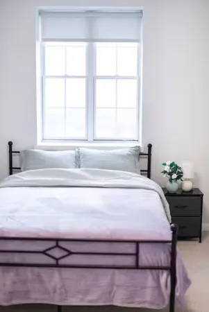 a bedroom with a bed and window