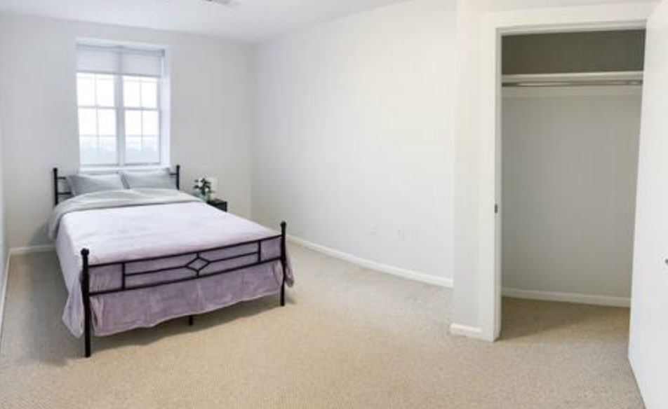 1505 Commonwealth Avenue, Unit 403 Boston, MA 02135 - Photo 13 of 16 a room with a bed and a window
