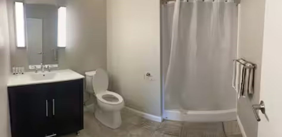 1505 Commonwealth Avenue, Unit 403 Boston, MA 02135 - Photo 15 of 16 a bathroom with a sink a toilet and shower