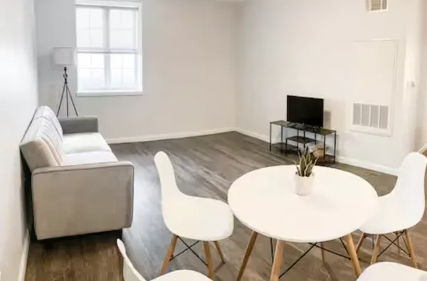 a dining room with furniture and wooden floor