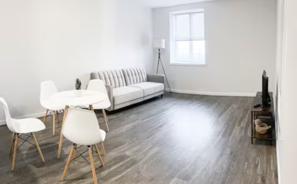 1505 Commonwealth Avenue, Unit 403 Boston, MA 02135 - Photo 5 of 16 a living room with furniture and a wooden floor