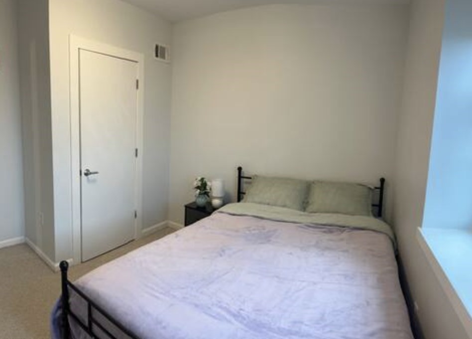 1505 Commonwealth Avenue, Unit 403 Boston, MA 02135 - Photo 10 of 16 a bedroom with a bed and a table in it