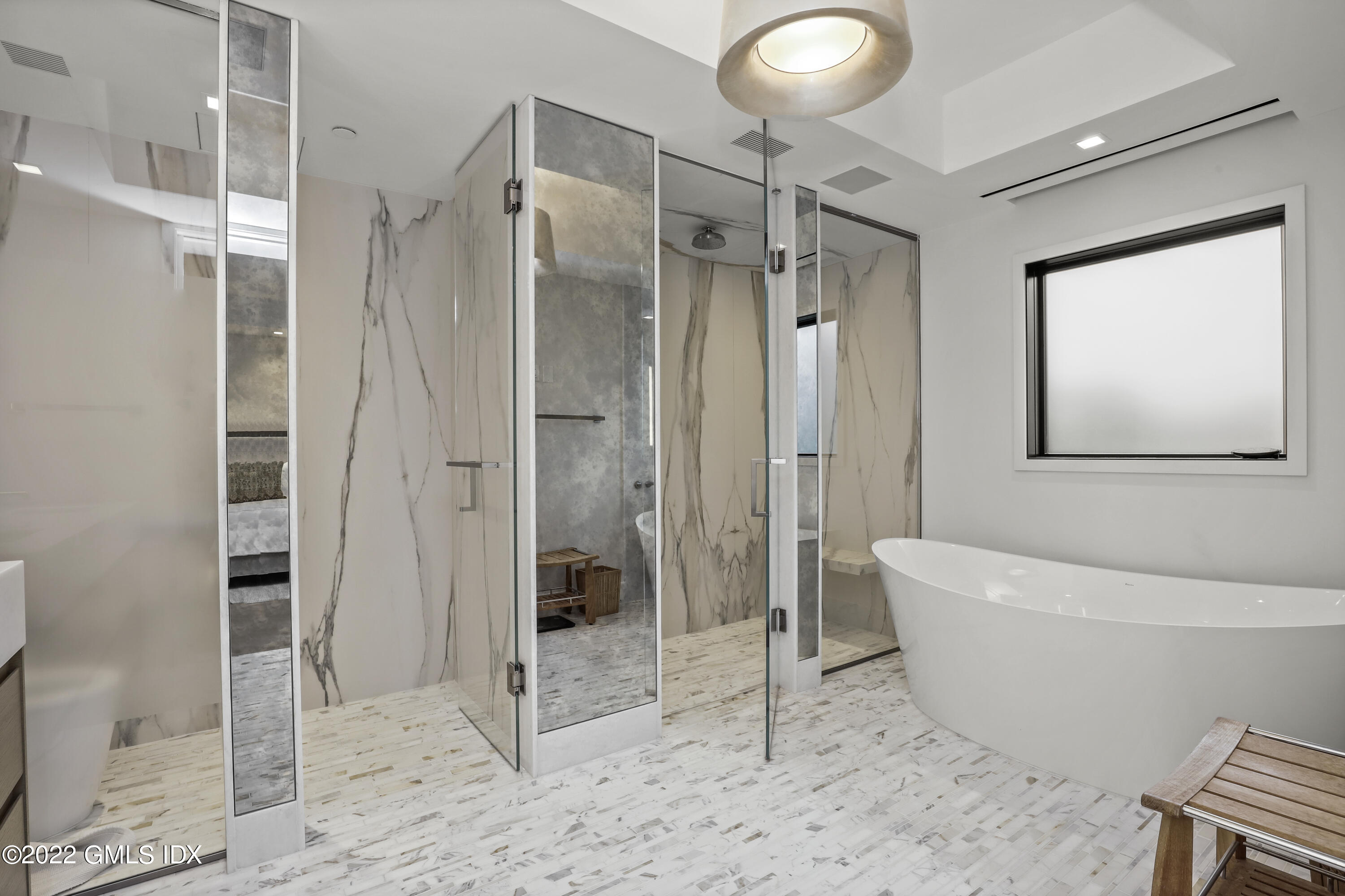 125 Field Point Road, Unit A4 Greenwich, CT 06830 - Photo 15 of 33 a spacious bathroom with a glass shower door and a bathtub