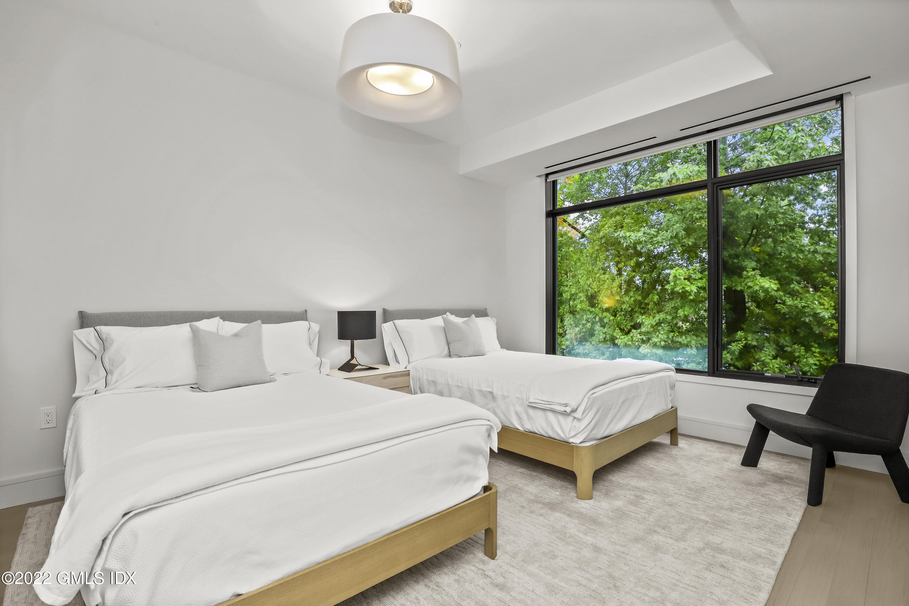 125 Field Point Road, Unit A4 Greenwich, CT 06830 - Photo 17 of 33 a bedroom with a bed and a large window