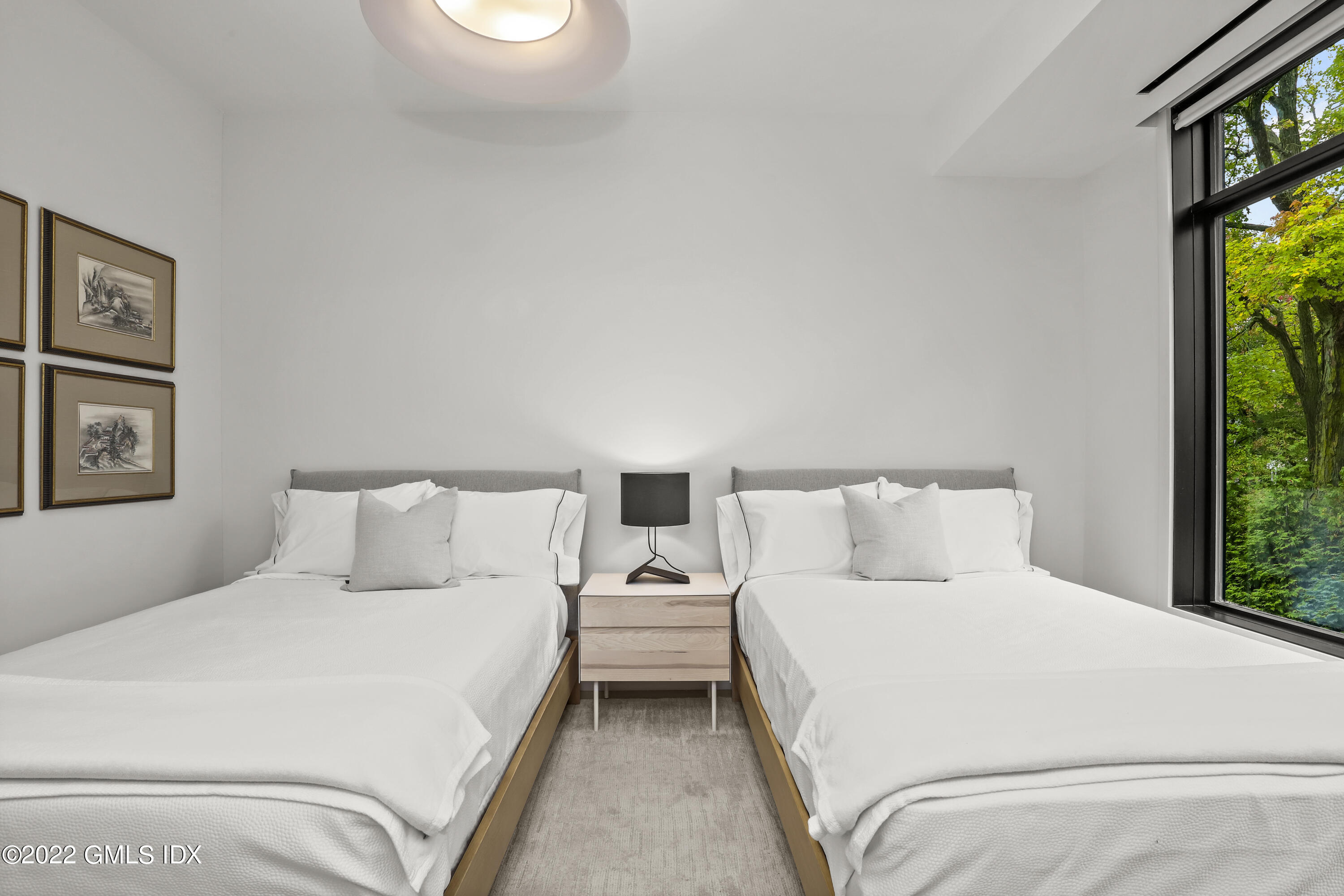 125 Field Point Road, Unit A4 Greenwich, CT 06830 - Photo 18 of 33 a bedroom with a bed and a tv