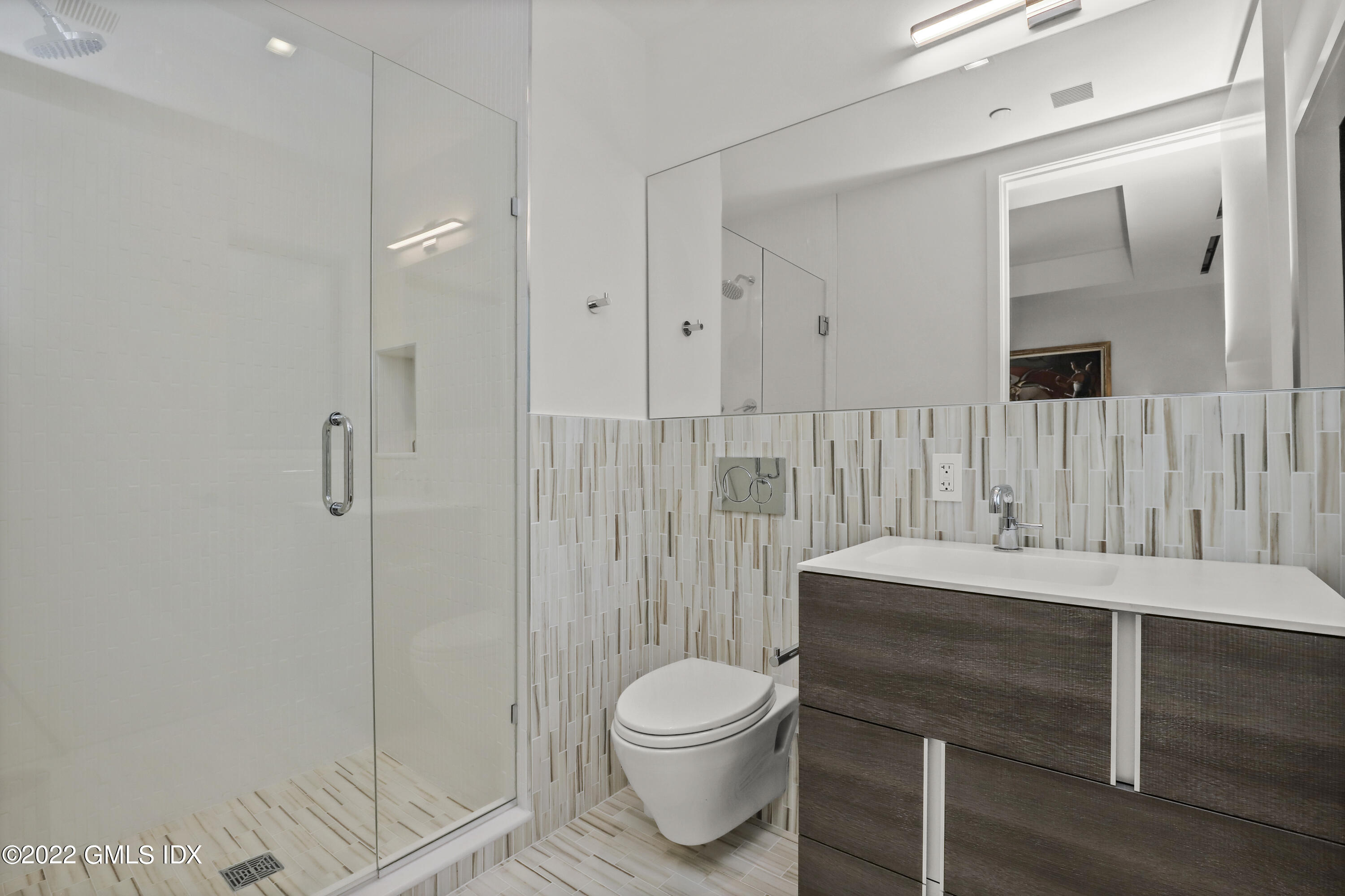 125 Field Point Road, Unit A4 Greenwich, CT 06830 - Photo 22 of 33 a bathroom with a sink toilet a mirror and shower