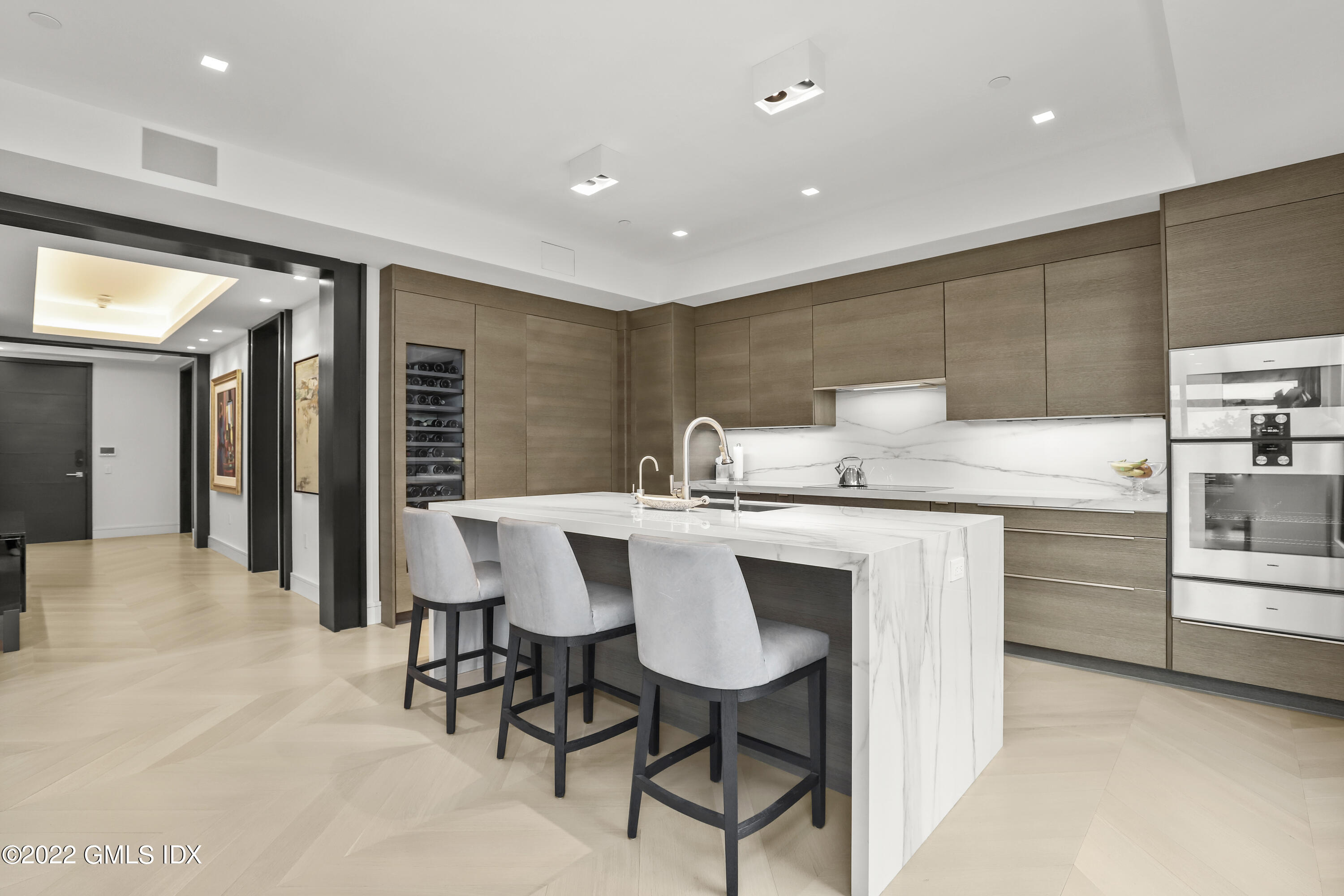125 Field Point Road, Unit A4 Greenwich, CT 06830 - Photo 7 of 33 a kitchen with stainless steel appliances kitchen island granite countertop a sink and cabinets