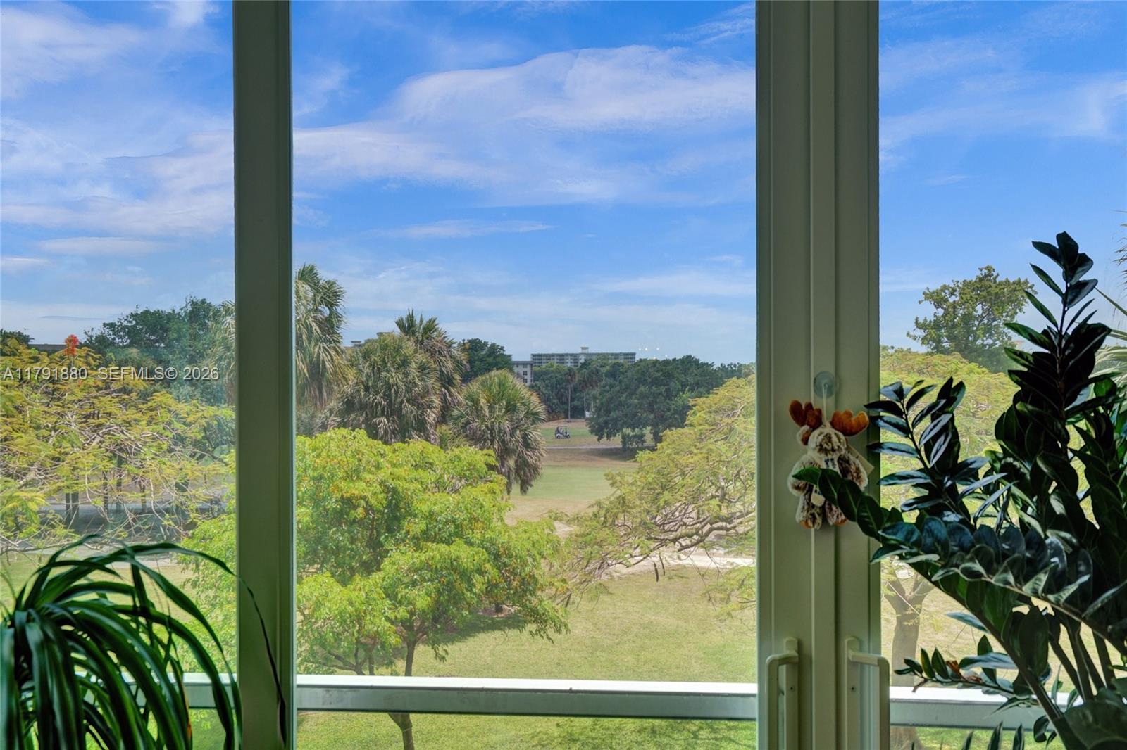3520 Oaks Way, Unit 308 Pompano Beach, FL 33069 - Photo 12 of 40 a view of a garden from a window