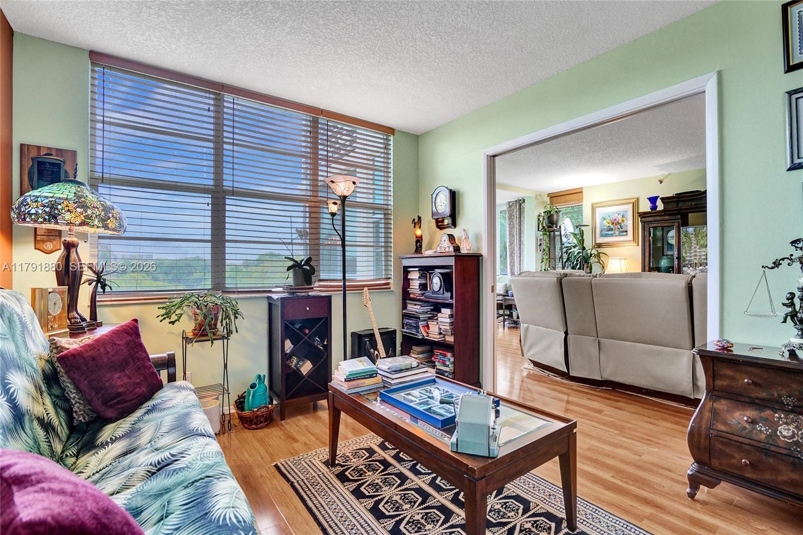 3520 Oaks Way, Unit 308 Pompano Beach, FL 33069 - Photo 14 of 40 a living room with furniture and wooden floor