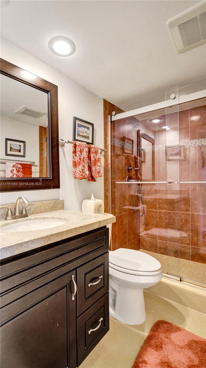 3520 Oaks Way, Unit 308 Pompano Beach, FL 33069 - Photo 16 of 40 a bathroom with a sink a toilet and shower
