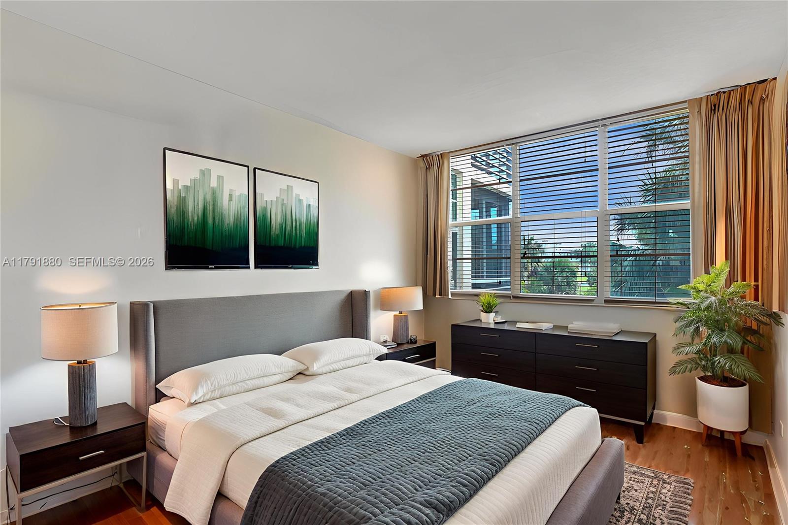 3520 Oaks Way, Unit 308 Pompano Beach, FL 33069 - Photo 19 of 40 a bedroom with a large bed and a large window